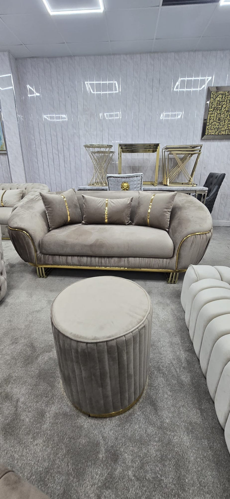 Gray sofa with gold accents in a modern living room setting
